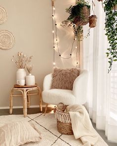 a living room filled with furniture and plants on top of a white rug next to a window