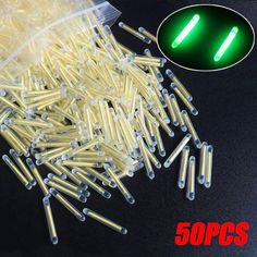 50 pcs green glowers for sewing and crafting with clear plastic bag on black background