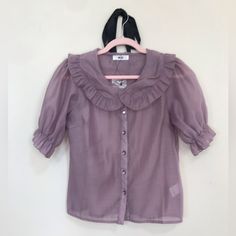 Japense Brand Wego Lavender Transparent Button Up Blouse With Statement Puff Sleeves Ending In Ruffles And Large Ruffled Collar Never Worn In Excellent Condition And Extra Button Still Attached To Tag Pearly Lavender Buttons Girly And Perfect For A Buzz Lightyear Or Tangled Disney Bound Cottagecore Feminine Crepe Texture Measurements: Armpit To Armpit = 19.5 Inches Length = 22.5 Inches Waist Across Laying Flat = 18.5 Inches Purple Blouse With Ruffled Collar, Feminine Purple Blouse With Ruffles, Purple Ruffled Collar Blouse With Ruffles, Purple Ruffle Puff Sleeve Tops, Vintage Button-up Ruffled Blouse, Tangled Disney, Lavender Blouse, Statement Collar, Button Up Blouse