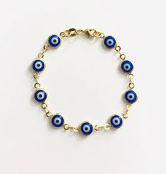 "18k gold filled dark blue evil eye bracelet for good luck, prosperity and protection. 5,25\" long for baby. pulsera de ojo azul oscuro de la buena suerte en 18k gold filled para prosperidad,buena suerte y poteccion. bebe 5,25\" largo." 14k Yellow Gold Evil Eye Bracelets, 14k Gold Bracelets With Evil Eye, Yellow Gold Round Evil Eye Bracelet, Yellow Gold Evil Eye Bracelet, Blue 14k Gold Round Bracelets, Blue Round Evil Eye Bracelets, Blue Evil Eye Round Bracelets, 14k Gold Round Evil Eye Bracelets, Adjustable Hypoallergenic Gold Evil Eye Bracelet