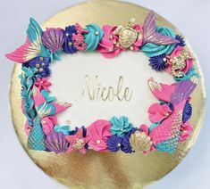 there is a cake decorated with pink, blue and purple flowers