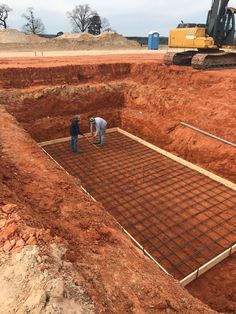 two men working on the foundation of a building