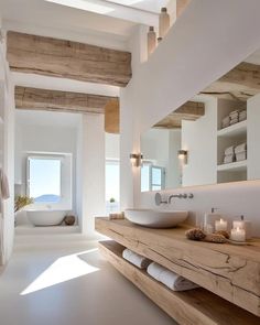 a bathroom with a sink, mirror and bathtub