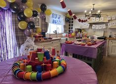 a birthday party with balloons, cake and decorations