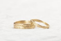 14k Solid Gold Wedding Bands His and Hers, Matching Wedding Rings, Floral Band I got the inspiration for these rings while I walked in the field outside of my studio Dainty 14K White gold engraved leaves Ring, handmade with great attention to detail, each leaf is engraved by hand to create this endless feeling of elegance design, the slight organic structure of this ring makes it so unique and special. ❀ A perfect engagement or wedding gift to your loved ones. Features: woman Band: ❇ The band is 1 mm / 0.04' Inch thick ❇ Band width: 1.5-2.5mm / 0.06'-0.10' Inch ❇ Avilable also in 14K White/ Rose Gold - choose at checkout. man Band: ❇ Band: 14K Gold- Can be made also in 18K ❇ Can be made in White / Rose Gold   - contact me for details. ❇ Ring width: 5mm / 0.20' Inch ❇ Band Thickness: 1.2 mm Yellow Gold 14k Stamped Wedding Couple Rings, Engraved Yellow Gold Wedding Ring, Heirloom Wedding Couple Rings Stamped 14k, Yellow Gold Wedding Couple Rings, Olive Leaves Wedding, Wedding Rings Floral, Wedding Bands His And Hers, Olive Leaf Ring, Leaf Wedding Rings