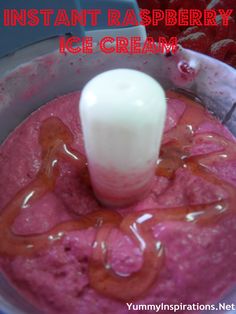 an ice cream blender with strawberries in it and the words instant raspberry ice cream