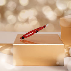 a red toothbrush sitting on top of a golden box