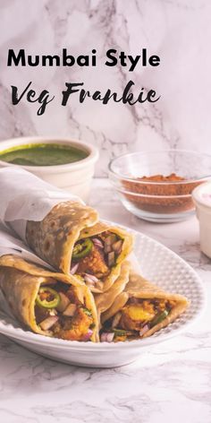 a white plate topped with three burritos on top of a marble countertop