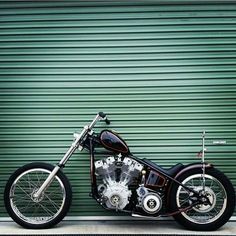 a motorcycle parked in front of a green garage door