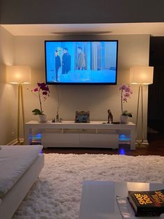 a large flat screen tv mounted to the side of a wall in a living room