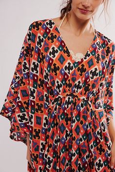 Billowy and breezy, vibrant and eye-catching, this so special kaftan is perfect for brunches, beach days, and everything in between. **Fit:** Maxi length, relaxed and oversized **Features:** Super mod, retro print, relaxed sleeves, pull-on style, deep-v neckline, ruched detailing, soft comfy fabrication **Why We | Groovy Baby Maxi Kaftan Dress by Free People Chic Printed Beach Kaftan, Chic Summer Tunic With Kimono Sleeves, Spring Vacation Kaftan With Vibrant Print, Orange Bohemian Beach Dress For Beach Party, Summer Flowy Kaftan With Kimono Sleeves, Summer Vibrant Print Kaftan For Beach, Beachwear Kaftan With Vibrant Print And Kimono Sleeves, Bohemian Summer Tunic With Vibrant Print, Beach Kaftan With Vibrant Print And Flowy Fit