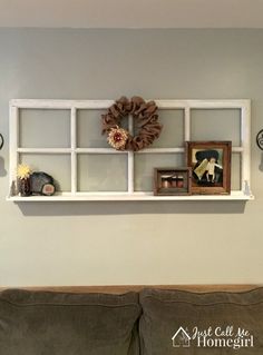 a living room filled with furniture and decor on top of a window sill next to a couch