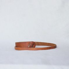 a brown leather belt on a white background