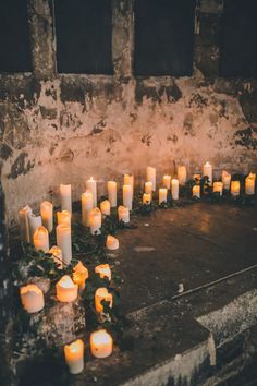 many lit candles are arranged in the shape of a heart