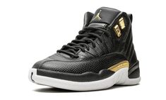 The Air Jordan 12 Retro "Snakeskin" is treating women to an outstanding lifestyle sneaker.  Souped up with style, the pair creates a premium colorway with the slick combination of black and metallic gold.  The offering brings a variety of textures as some areas are covered in smooth leather and others display different snakeskin patterns.  The luxe Air Jordan 12 is rounded out with metallic gold lacelets and a matching midfoot plate, as well as a white outsole finish. Snake Skin Shoes, White Jordans, Air Jordan 12, Air Jordan 12 Retro, Womens Air Jordans, Jordan 12 Retro, Jordan 12, Jordans 12, Black Metallic