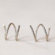 Tiny Double Hoop Earrings, Minimal Spiral Earrings, Tiny Twist Earrings, Double Hoop Earrings, Double Piercing, Diamond Cut Hoop EarringsTwist these little coils in and instantly get the appearance of two lobe piercings.(You only need ONE piercing to make these work-- they give the look of two!)(It can also be worn with two holes in case you have them)All you do is thread one side through your first hoop until the other side sits comfortably on your earlobe giving the illusion of a second hole. Spiral Nickel-free Hoop Earrings For Everyday, Spiral Hypoallergenic Hoop Earrings, Adjustable Spiral Hoop Earrings, Minimalist Spiral Hoop Earrings For Pierced Ears, Minimalist Spiral Hoop Earrings, Two Lobe Piercings, Earrings Double Piercing, Twist Earrings, Lobe Piercings