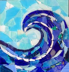 a blue and white mosaic art piece with waves in the center, on a table