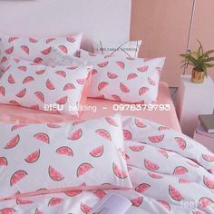 a bed with watermelon print on it and pink sheets, pillows and pillow cases