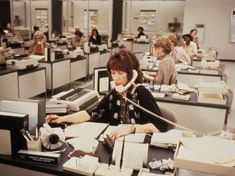 an office filled with people working on telephones