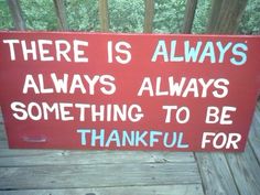 a red sign that says there is always something to be grateful for on the porch