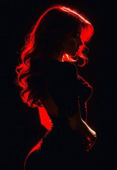 the silhouette of a woman with long hair in red light, against a black background