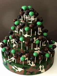 a camouflage cake decorated with green and brown candies