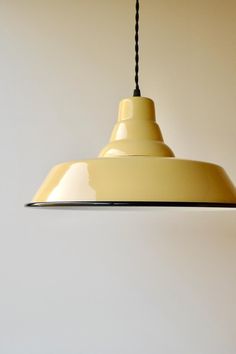 a yellow light hanging from a ceiling in a room