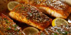 salmon fillets with lemons and seasoning in a pan