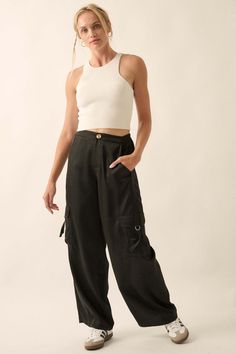 Matte-finish satin cargo pants. Side cargo flap pockets with strap closure. Buttoned waist closure and zip-up fly. High waist. Wide leg. Elastic-back waist. Relaxed fit. 100% Polyester. Imported. Designed in LA. Model wears size S. Black Cropped Bottoms With Pockets, Cropped Black Bottoms With Pockets, Cropped Streetwear Bottoms With Pockets, Cropped Bottoms With Pockets For Streetwear, Casual Cropped Cargo Pants With Pockets, Satin Cargo Pants, Fly High, Matte Satin, Vintage Canvas