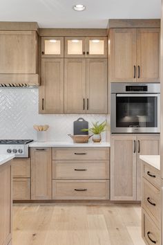 a kitchen with wooden cabinets and white counter tops