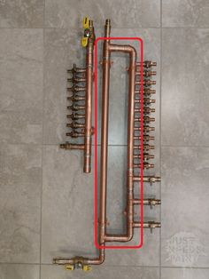 the pipes are connected to each other on the tile floor with red lines running through them