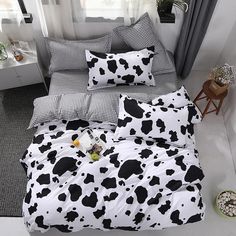 a black and white cow print bed spread