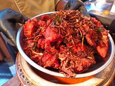 a bowl full of food sitting on top of a table