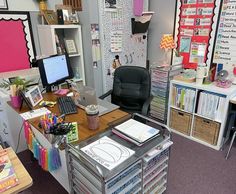 an office area with desk, computer and bookshelves full of papers on it