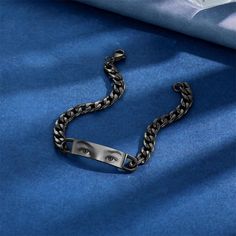 a close up of a chain on a blue cloth with an eye in the middle