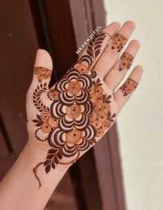 a woman's hand is decorated with hendi and flower designs on the palm