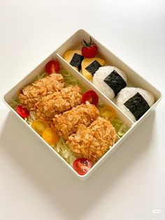 two small bowls filled with food on top of a white table