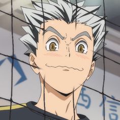 an anime character with short hair and eyes looking at the camera from behind a wire fence