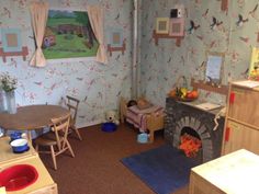 a child's playroom with toys and furniture, including a toy fire place