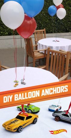 a table topped with balloons and hot wheels cars