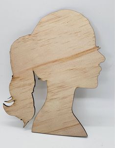 a wooden cutout of a woman's head