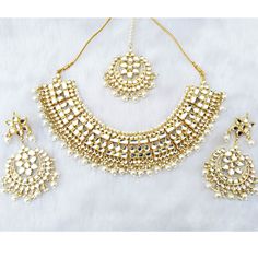 "Gorgeous Shiny Bridal Wedding Designer Meena Kundan necklace Set Contains a awesome choker necklace that Fixs the Neck, a Pair of Earrings and Maang Tika(Head Piece) embedded with Semi-precious Stones like Pearl,glass. This product is handmade & hence the product can be non-uniform & vary in color & texture. Color : White Gorgeous Meena Kundan Gold Plated Necklace jewelry Set 1.Set consists of Necklace, Earrings,Maang Tikka set 2. Necklace Size:(4.5\"L X 6.5\"W) 3.Necklace Weight: 2 White Bollywood Jewelry For Marriage, Maang Tikka Set, Kundan Choker Necklace, Kundan Necklace Set, Necklace Set Indian, Kundan Choker, Maang Tikka, Kundan Necklace, Kundan Necklaces