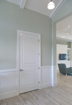 an empty living room with white walls and wood floors