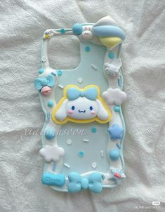 a cell phone case that is made to look like it has clouds and stars on it