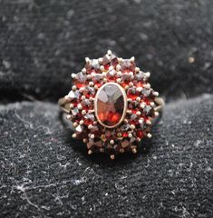 This is a beautiful antique garnet cluster ring set in 900 silver. The ring has a tiered design, and the top tier does wiggle some, though it is likely not at risk of coming off. Overall, the piece is in very great shape and was likely made in the late-1800s or early-1900s. Size US 5.5 Top Dimensions: 0.75in x 0.6in Cluster Ring Set, Cluster Ring, Rings Statement, Garnet, Statement Rings, Ring Size, Jewelry Rings, Beauty Book, Silver Rings