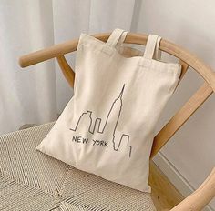 a tote bag sitting on top of a wooden chair