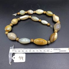 The Rare and Unique Himalayan Indo Tibetan Solumani Banded Agate Beads Necklace Mala The Age of this Beads are More than 2000 Years Old In Ancient Times Agate was valued as a Talisman. It was Used In Ancient times as Prayer Beads In Prayer Malas and Used as Amulet Beads It was Used In Ancient Times as Jewelry and Used as trade Item as well Very Smooth and Oily Skin Surface Of this Beads Some Gold Plated Wax Beads are Used as Spacers Fast and Free Shipping Service Enjoy Artisan Gemstone Oval Beads, Artisan Beaded Necklace With Polished Agate, Artisan Agate Beaded Necklaces With Polished Beads, Artisan Gemstone Beaded Necklace, Artisan Beaded Necklace With Oval Gemstones, Polished Oval Agate Beads, Oval Agate Beaded Necklaces, Agate Necklaces With Polished Oval Beads, Wax Beads