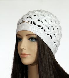 a mannequin head wearing a white crochet hat