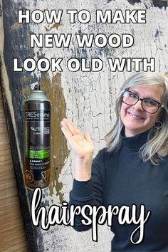 a woman holding up her hand next to an old sign with the words how to make new wood look old with hairspray