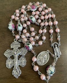 "This beautiful handmade rosary is made with 6mm pink  glass beads, 8mm ceramic beads and 2\"  crucifix.   Length: 20\" inches long" Adjustable Pink Rosary Bracelet With 8mm Beads, Pink Rosary With 8mm Round Beads, Pink Spiritual Rosary Bracelet With 8mm Beads, Pink 8mm Bead Spiritual Rosary Bracelet, Pink 8mm Beads Rosary Bracelet, Pink Beaded Spiritual Rosary, Mother's Day Rosary With 8mm Beads, Pink Beaded Rosary With Round Beads, Handmade Pink Spiritual Rosary